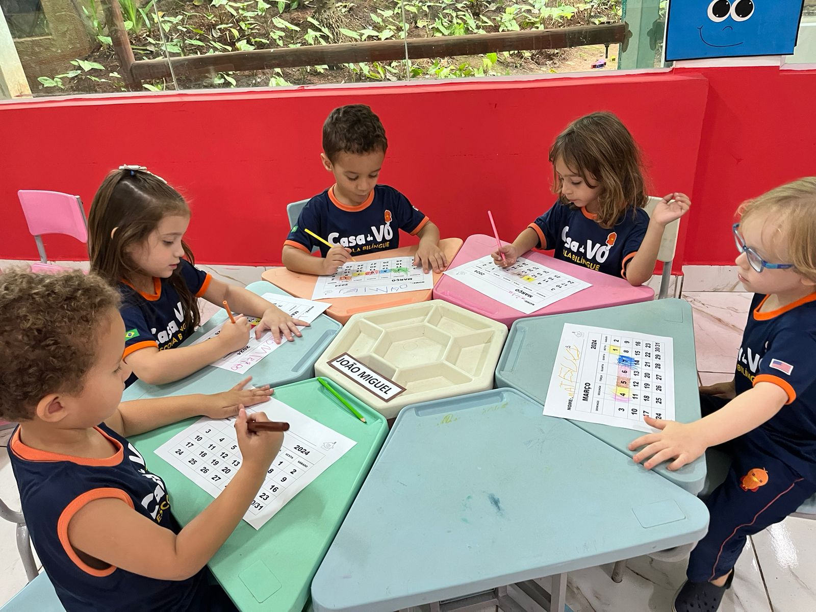 Grupo de crianças estudando juntas na Casa de Vó Escola Bilíngue